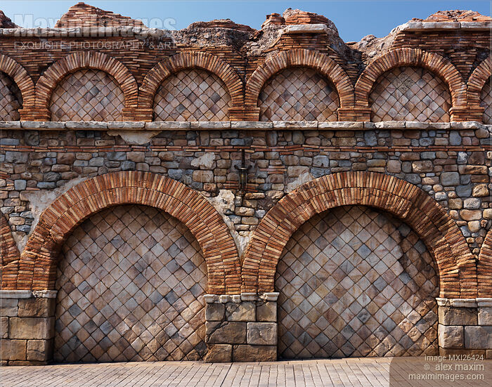 Old stone wall with brick arches texture Stock photo of Old stone wall with brick arches texture Buy commercial use license at MaximImages