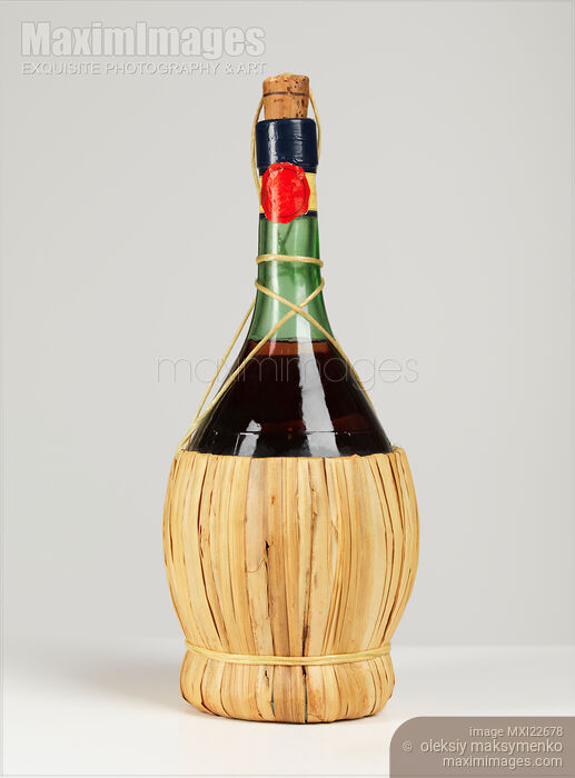Stock photo of Old Wicker Bottle of Wine Buy commercial use license at MaximImages