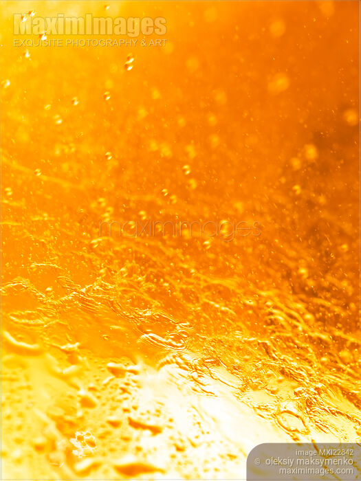 Stock photo of Orange splashing water abstract background Buy commercial use license at MaximImages