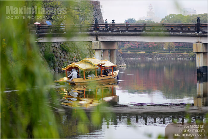 Stock photo of Osakajo Gozabune Boat sightseeing ride in Osaka Castle Park inner moat under Gokurakubashi bridge Buy commercial use license at MaximImages
