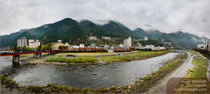 Stock photo of Panoramic scenery of hot springs resort town Gero Japan with foggy mountains Buy commercial use license at MaximImages