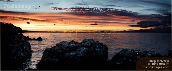 Stock photo of Panoramic sunset sky scenery of rocks on the ocean shore in Nanaimo Vancouver Island Buy commercial use license at MaximImages