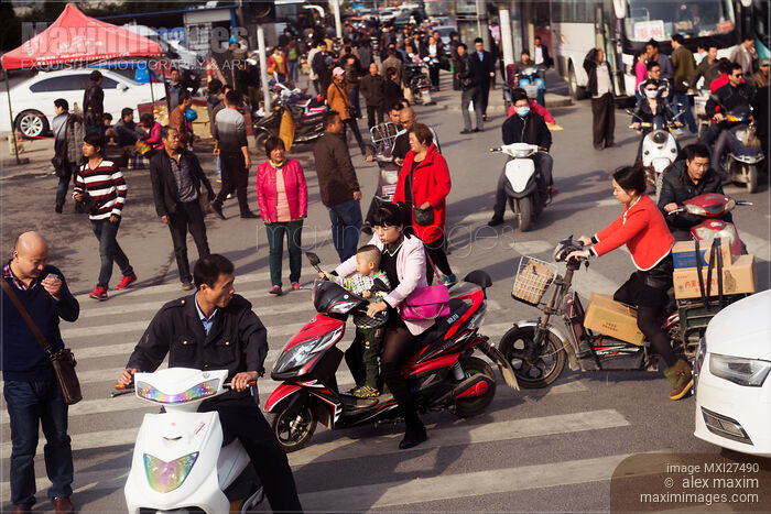 Stock photo of People and traffic at intersection in China Buy commercial use license at MaximImages