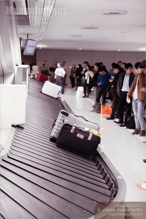 Stock photo of People at airport baggage claim conveyor Buy commercial use license at MaximImages