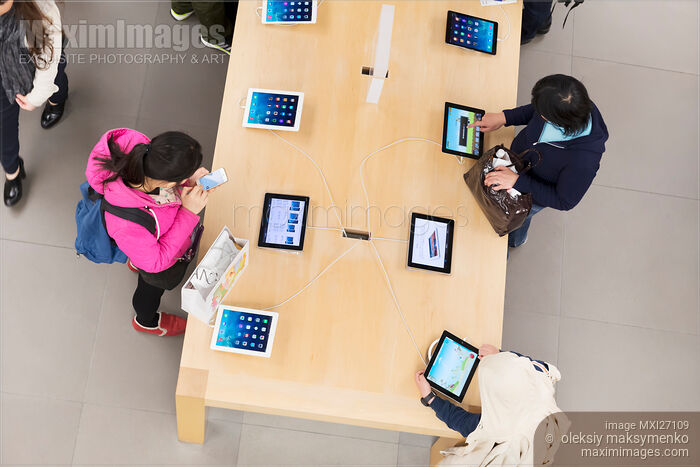People at Apple store trying new iPads Stock photo of People at Apple store trying new iPads Buy commercial use license at MaximImages