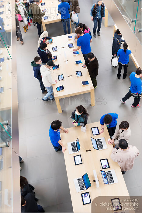 People at Apple store trying new products Stock photo of People at Apple store trying new products Buy commercial use license at MaximImages