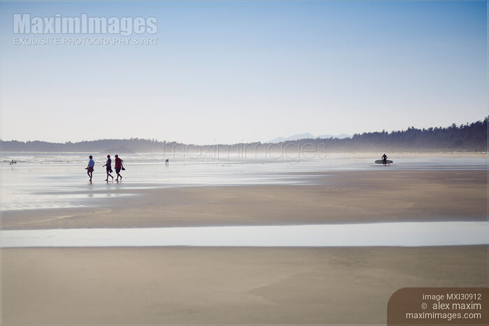 People at the Pacific Rim National Park walking along the sandy beach of Pacific ocean Stock photo of People at the Pacific Rim National Park walking along the sandy beach of Pacific ocean Buy commercial use license at MaximImages