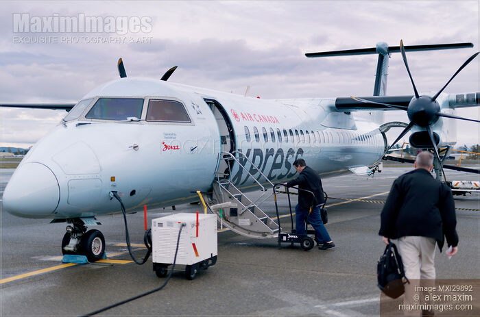Stock photo of People boarding Air Canada Jazz Express plane at Victoria International Airport Buy commercial use license at MaximImages
