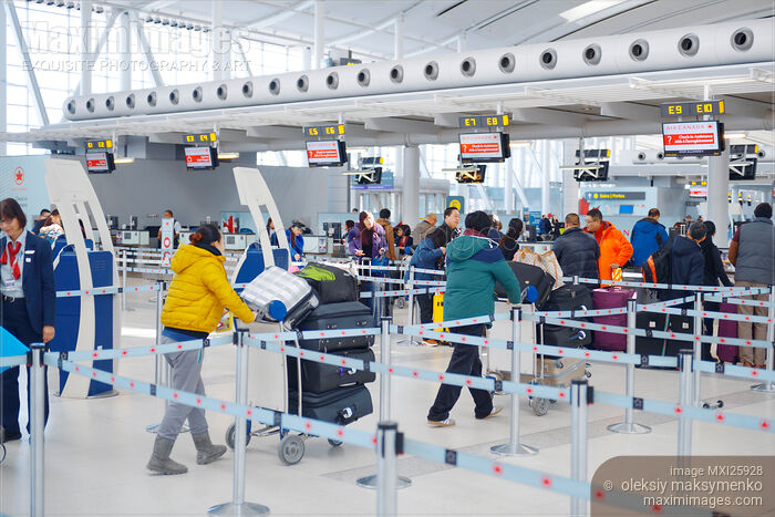 Stock photo of People checking in their baggage at airport Buy commercial use license at MaximImages
