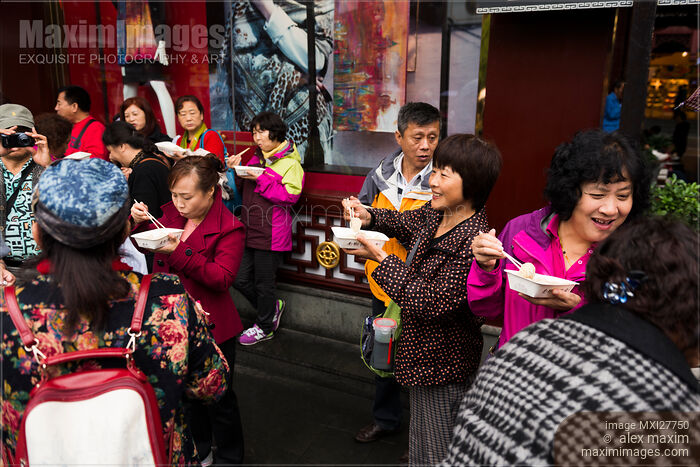 Stock photo of People eating dumplings at The Old City of Shanghai Buy commercial use license at MaximImages