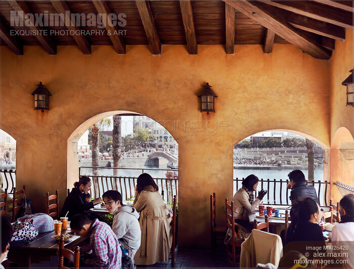 Stock photo of People eating on balcony of a restaurant Buy commercial use license at MaximImages
