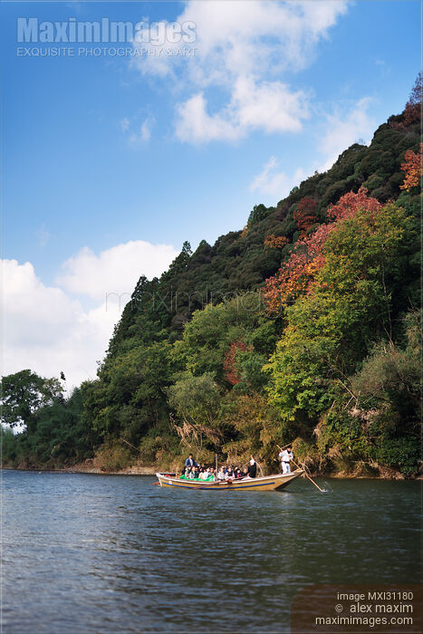 Stock photo of People enjoying a sightseeing ride on Hozugawa river boat cruise in Kameoka Buy commercial use license at MaximImages