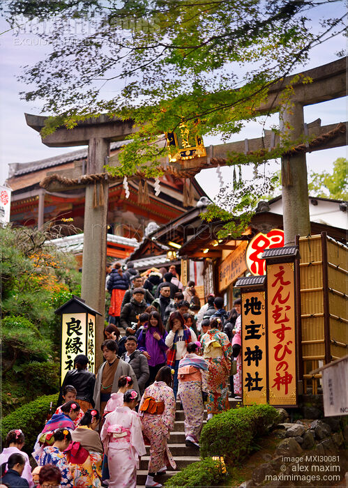 Stock photo of People entering Torii gate to Jishu-Jinja shrine at Kiyomizu-dera Buddhist temple in Kyoto Japan Buy commercial use license at MaximImages