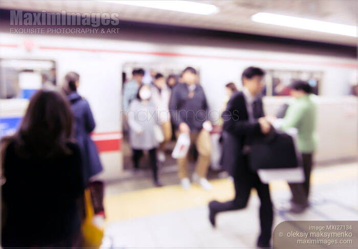 Stock photo of People getting off subway train in Tokyo Abstract concept Buy commercial use license at MaximImages