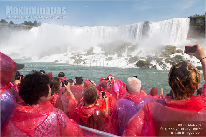 Stock photo of People in pink raincoats on boat ride at Niagara Falls Buy commercial use license at MaximImages