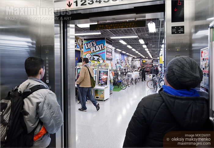 Stock photo of People inside elevator in store Buy commercial use license at MaximImages