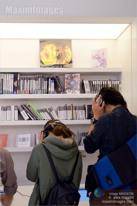 Stock photo of People listening to music at a store Buy commercial use license at MaximImages