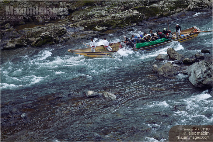 Stock photo of People on Hozugawa river sightseeing cruise boat ride in Japan Buy commercial use license at MaximImages
