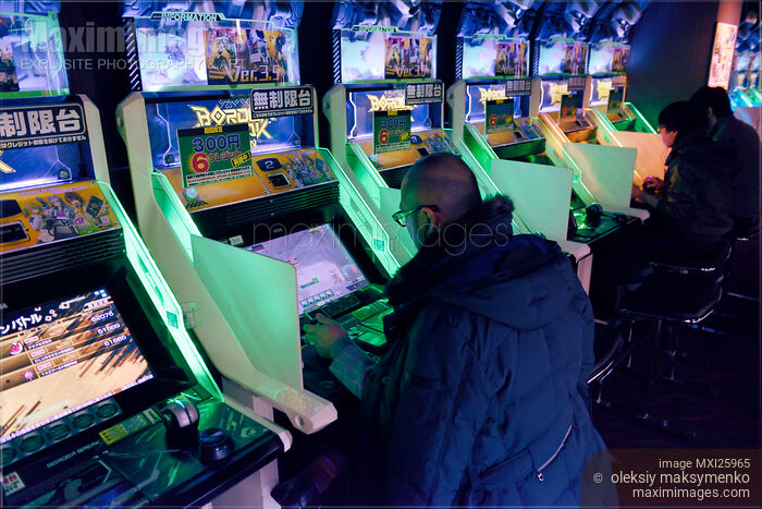 Stock photo of People playing Border Break arcade slot machines Buy commercial use license at MaximImages