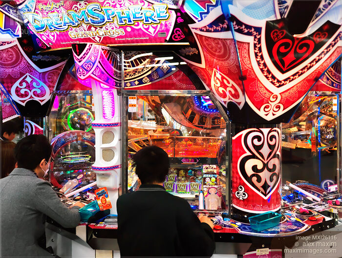 Stock photo of People playing DreamSphere slot machine at arcade in Odaiba Tokyo Buy commercial use license at MaximImages