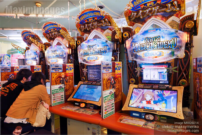 Stock photo of People playing slot machines at arcade in Japan Buy commercial use license at MaximImages