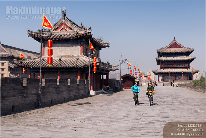 People riding bikes on Xi'an city wall in China Stock photo of People riding bikes on Xi'an city wall in China Buy commercial use license at MaximImages