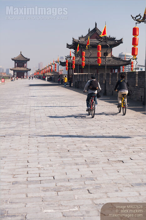People riding bikes on Xi'an city wall in China Stock photo of People riding bikes on Xi'an city wall in China Buy commercial use license at MaximImages