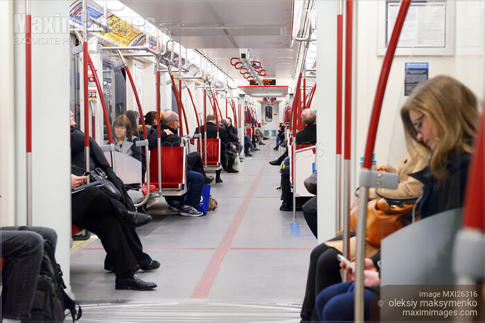 Stock photo of People riding subway train Buy commercial use license at MaximImages
