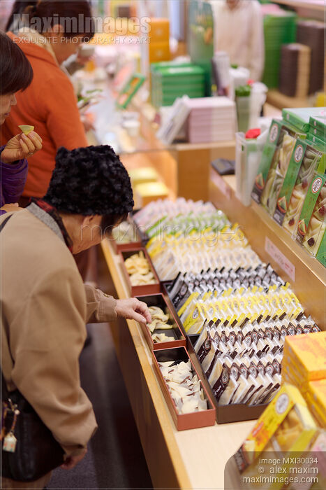 Stock photo of People sampling Japanese sweets Yatsuhashi at souvenir confectionery store in Kyoto Buy commercial use license at MaximImages