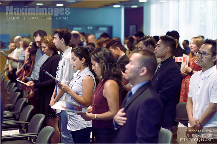 People singing Canadian national anthem O-Canada at a Citizenship ceremony Stock photo of People singing Canadian national anthem O-Canada at a Citizenship ceremony Buy commercial use license at MaximImages