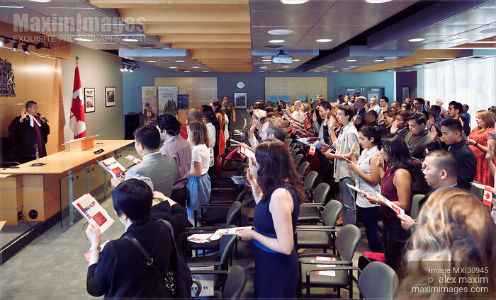 People taking a Citizenship Oath at a Citizenship ceremony in Canada Stock photo of People taking a Citizenship Oath at a Citizenship ceremony in Canada Buy commercial use license at MaximImages