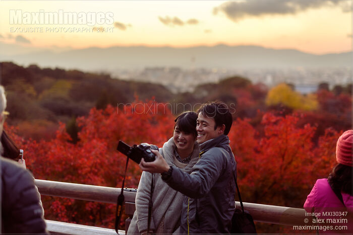 People taking a picture of themselves at Kiyomizu-dera in autumn sunset Kyoto Japan Stock photo of People taking a picture of themselves at Kiyomizu-dera in autumn sunset Kyoto Japan Buy commercial use license at MaximImages