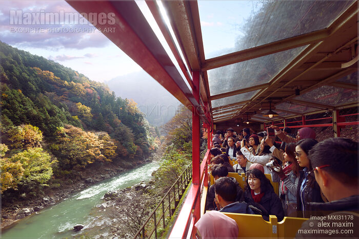 Stock photo of People taking pictures of Hozukyo Ravine scenery on Sagano Romantic train ride Buy commercial use license at MaximImages