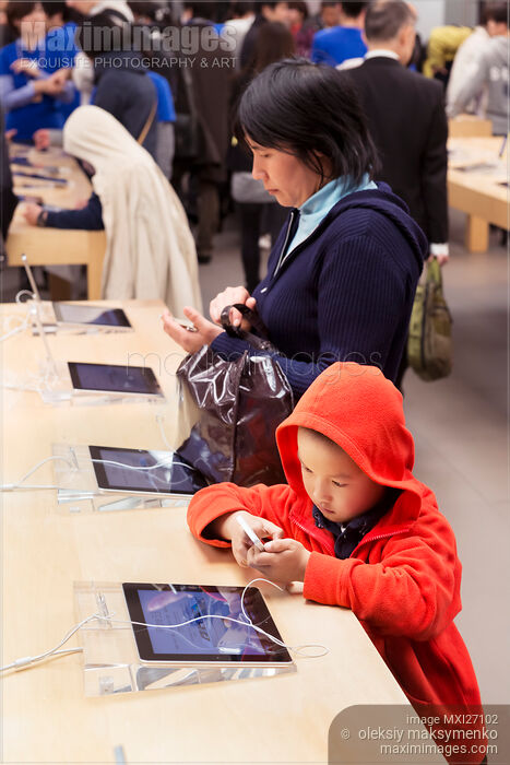 Stock photo of People trying new iPhone at Apple store in Japan Buy commercial use license at MaximImages