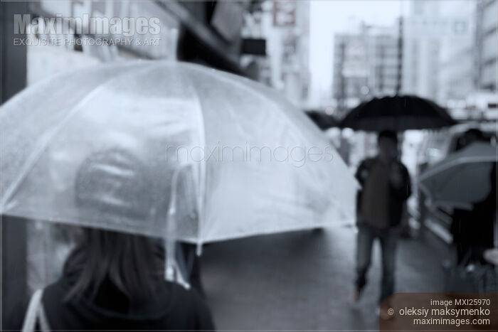 Stock photo of People with umbrellas on street in rain Buy commercial use license at MaximImages