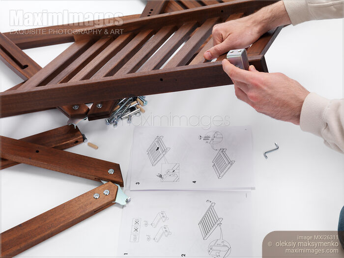 Person assembling IKEA furniture parts Stock photo of Person assembling IKEA furniture parts Buy commercial use license at MaximImages