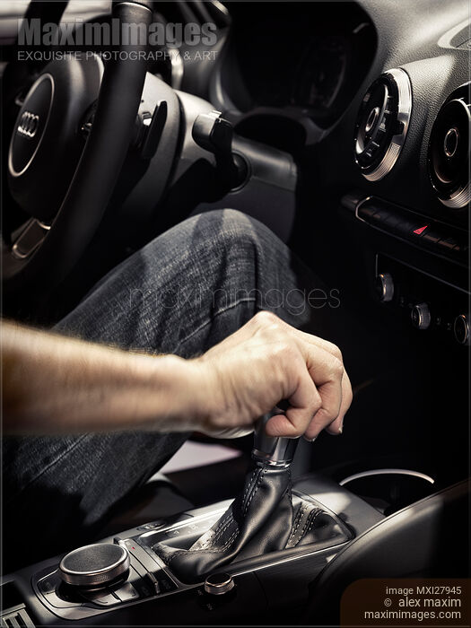 Stock photo of Person hand on a car gear stick Buy commercial use license at MaximImages