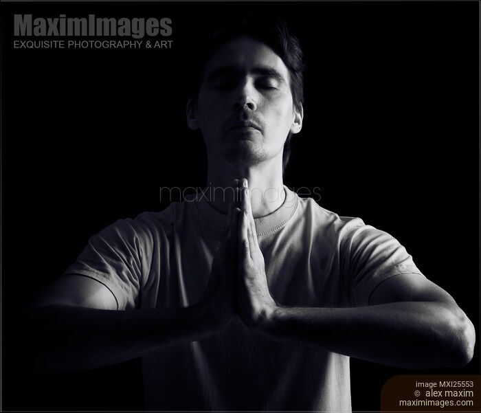 Stock photo of Person meditating with hands clasped Buy commercial use license at MaximImages