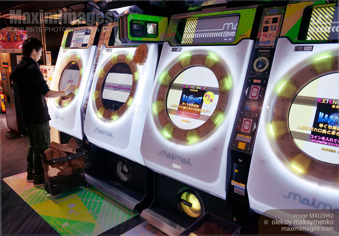 Person playing at an arcade in Japan Stock photo of Person playing at an arcade in Japan Buy commercial use license at MaximImages