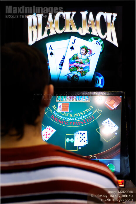 Stock photo of Person Playing Black Jack Slot Machine in a Casino Buy commercial use license at MaximImages