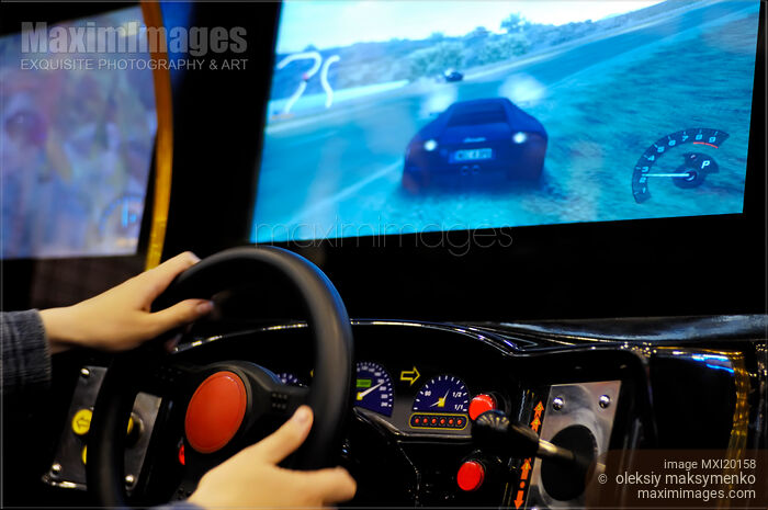 Stock photo of Person Playing Rally Video Game Buy commercial use license at MaximImages