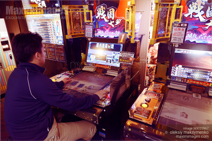 Stock photo of Person playing Sangokushi Taisen arcade slot machines Buy commercial use license at MaximImages
