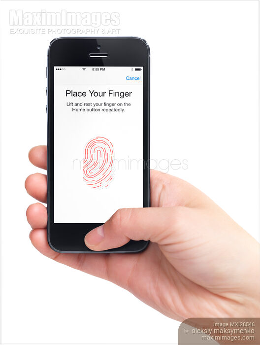 Stock photo of Person thumb on iPhone fingerprint sensor Buy commercial use license at MaximImages