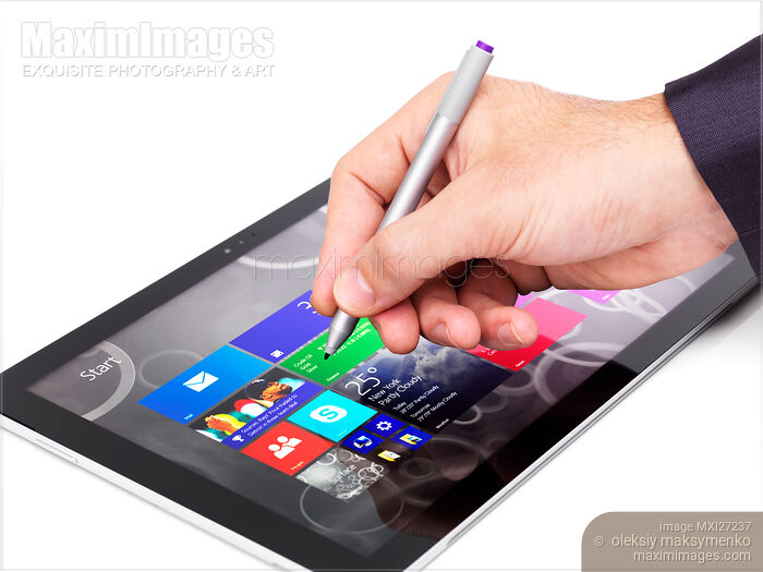 Stock photo of Person using Microsoft tablet Surface Pro 3 Buy commercial use license at MaximImages
