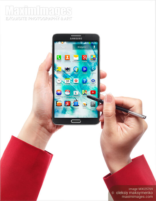 Stock photo of Person using Samsung Galaxy Note III Buy commercial use license at MaximImages