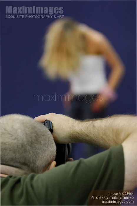 Stock photo of Photographer Taking Pictures of a Model Buy commercial use license at MaximImages