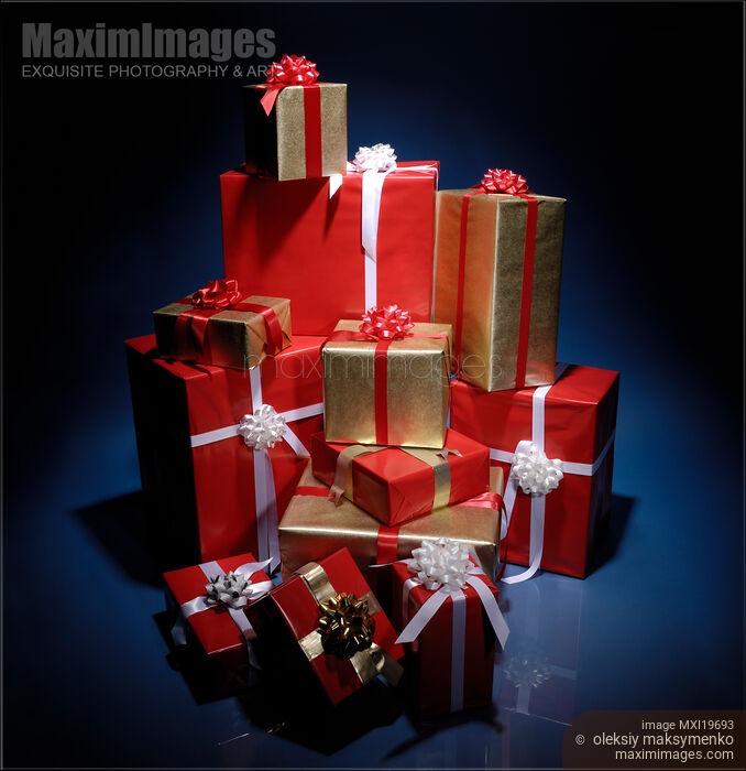 Pile of Christmas boxes in dark background Stock photo of Pile of Christmas boxes in dark background Buy commercial use license at MaximImages