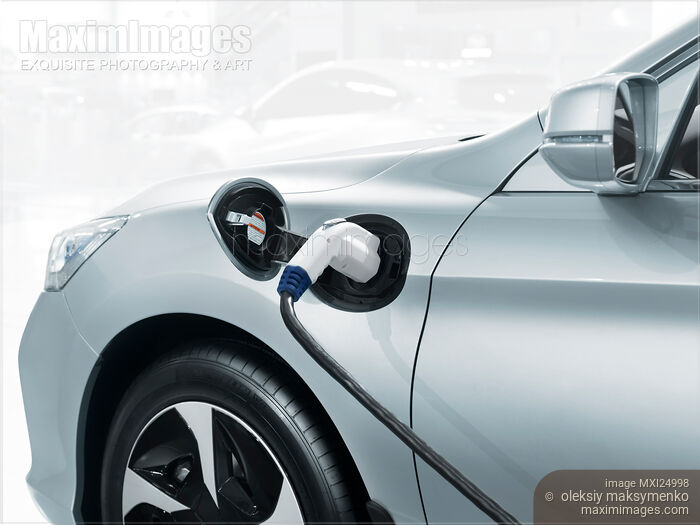 Stock photo of Plug-in electric car recharging battery Buy commercial use license at MaximImages