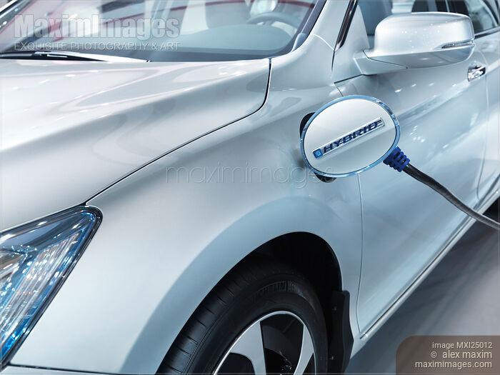 Stock photo of Plug-in hybrid electric car at charge station Buy commercial use license at MaximImages