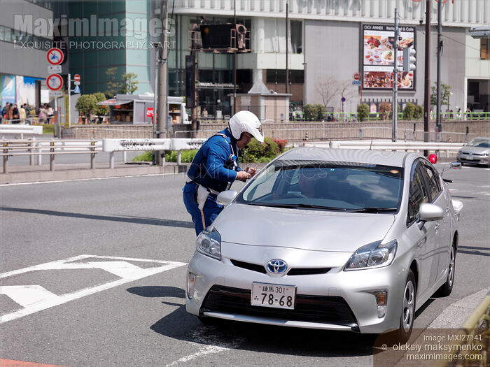 Stock photo of Police officer stopping a car Buy commercial use license at MaximImages